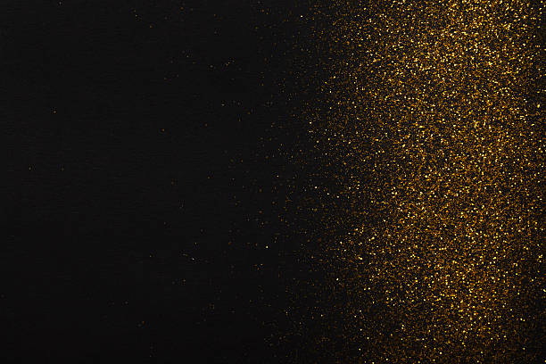 istock Golden glitter sand texture border on black, abstract background. 619535790