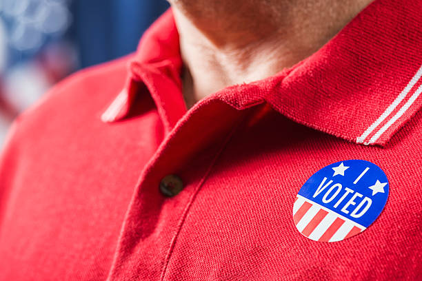 istock I VOTED sticker worn by man after voting 619536330