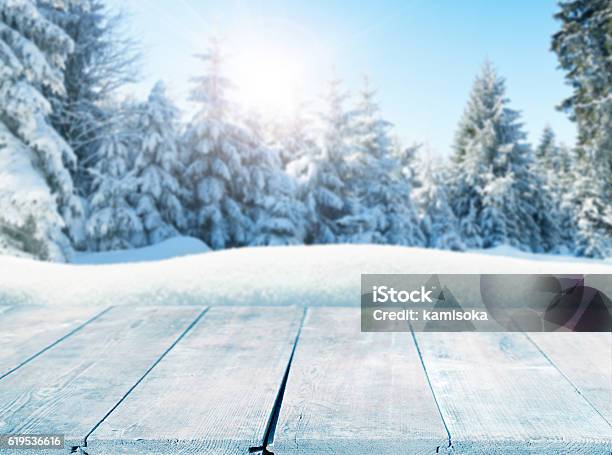 Winter Background With Snowcovered Pine Trees Behind Empty Wooden Planks Stock Photo - Download Image Now