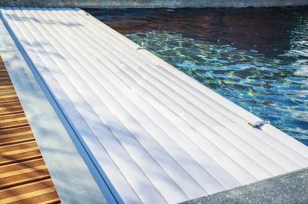 closeup on swimming pool roller-shutter covers