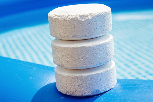 Chlorine Pellets on the edge of an inflatable pool Chlorine Pellets on the edge of an inflatable pool chlorine stock pictures, royalty-free photos & images