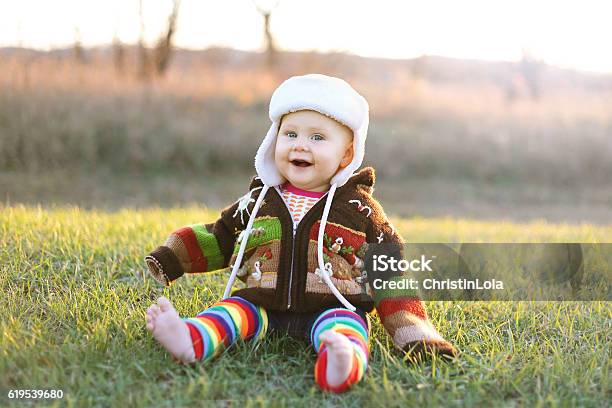 Adorable Baby Girl In Winter Hat And Sweater Laughing Outside Stock Photo - Download Image Now