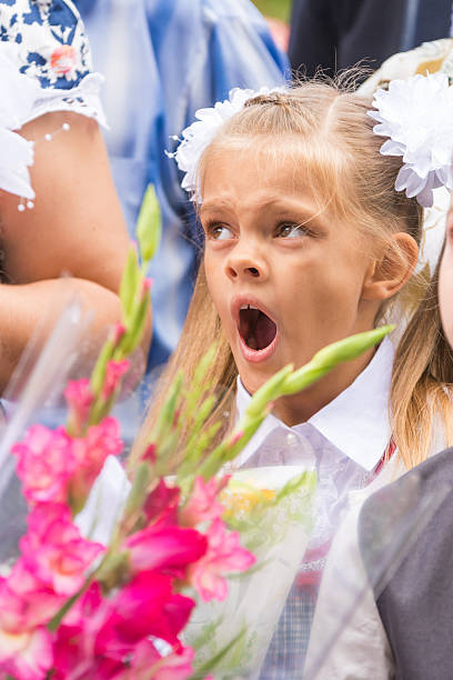 istock First grader yawning on line the first of September 619540074