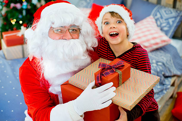 istock Santa Claus and cute boy getting ready for Christmas 619540318