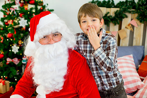 istock Santa Claus and cute boy getting ready for Christmas 619541008