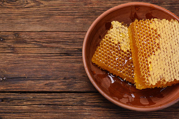 istock honeycomb on a wooden table, top view 619543220
