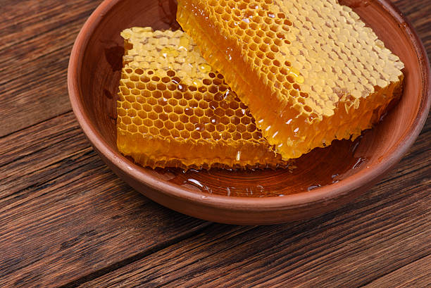 istock honeycomb on a wooden table 619543354