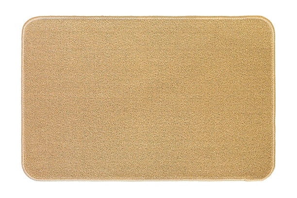 istock New clean floor rug, doormat in beige isolated on white 619543420