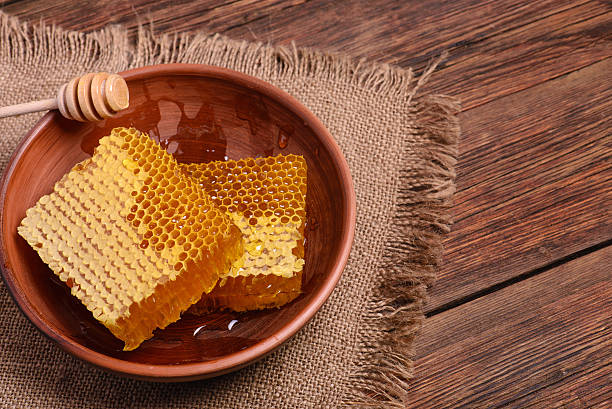 istock honeycomb in plate on a wooden table, copy space 619543530