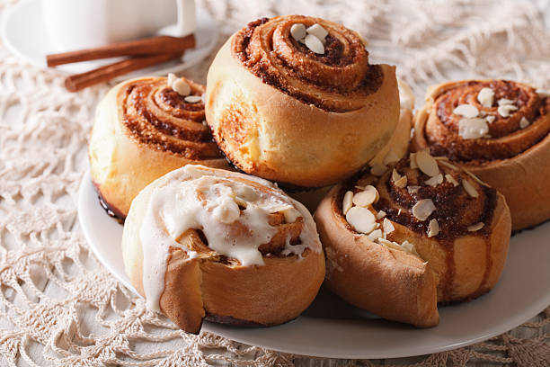 istock Freshly cinnamon rolls with almond close up and coffee. horizontal 619545054