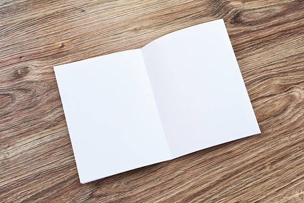 Open blank brochure, magazine is on a wooden desk