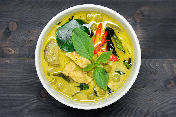 green curry with chicken green curry with chicken (Kang Keaw Wan Gai) on wooden background top view, Thai local food thai food stock pictures, royalty-free photos & images