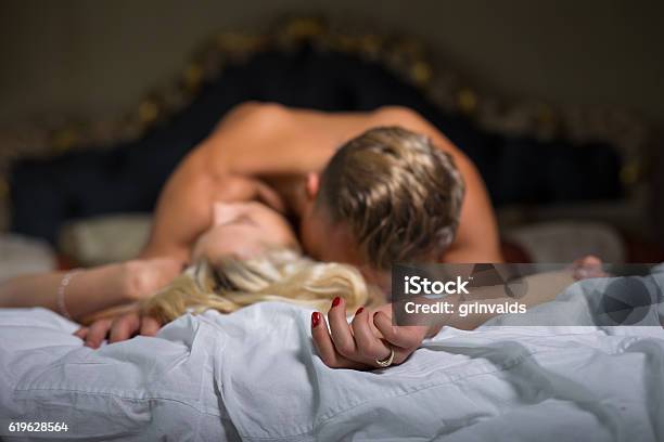 Man Kissing Womans Neck While She Is Lying Down Stock Photo - Download Image Now - Sexual Issues, Sex and Reproduction, Positioning