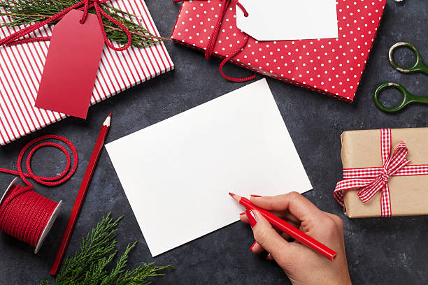 istock Female writing christmas greeting card 619628632
