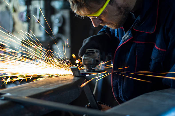 istock Factory worker using electric grinder in METAL INDUSTRY. 619629568