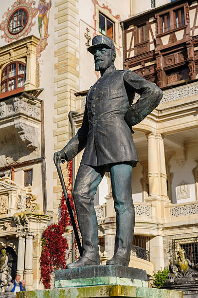 Peles, Sinaia, Romania - 19th October 2016: King Carol I statue in front of the Beautiful Peles castle and ornamental garden in Sinaia, Romania, between Valachia and Transylvania
