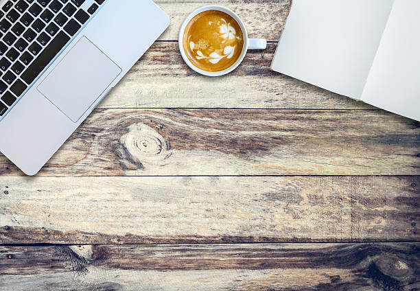 istock Top view laptop coffee notebook on old wood plank. 619630786