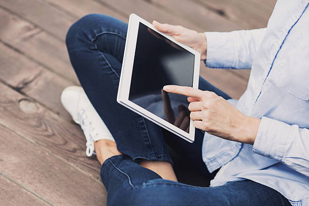 istock Girl using digital tablet outdoors 619631012
