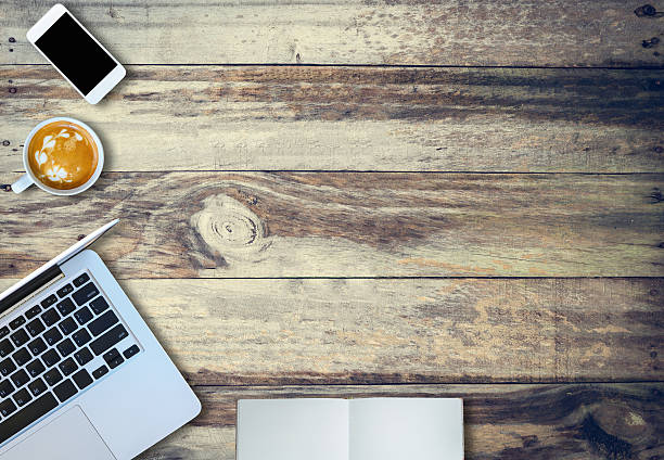 istock Laptop notebook coffee and mobile phone top view on oldwood. 619631496