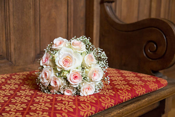 istock Romantic fresh wedding bouquet on red wooden bench 619632976