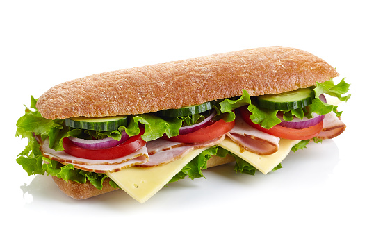 Fresh submarine sandwich with ham, cheese, tomatoes, cucumbers, lettuce and onions isolated on white background