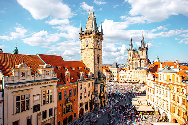 Prague cityscape view Cityscape view on the clock tower and Tyn cathedral on the old square in Prague. czech republic stock pictures, royalty-free photos & images