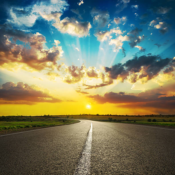 istock good sunset in clouds and asphalt road 619644872
