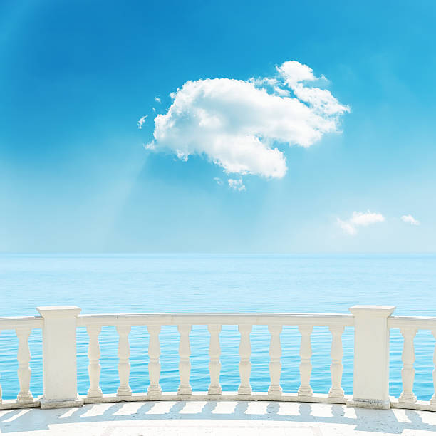 istock balcony near sea and white cloud in blue sky 619645312