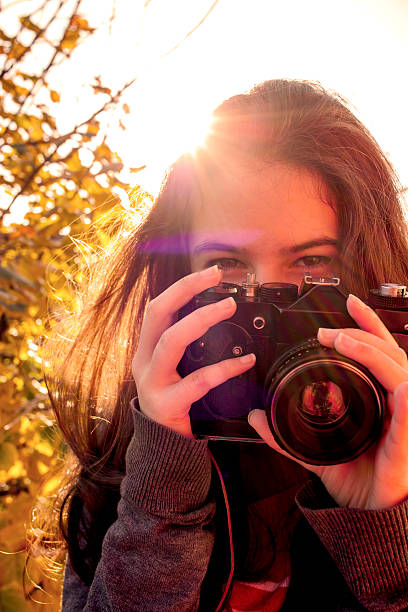 istock teenage girl holding analog camera 619645340