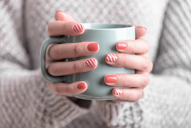 istock Women's hands holding a cup of drink. 619645504