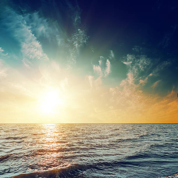 istock sunset in dark sky over sea with reflections 619645914