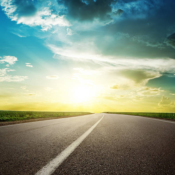 istock asphalt road to horizon in sunset 619646272