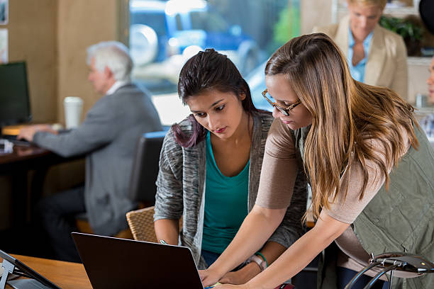istock Young Caucasian IT female IT support employee helps woman 619646366