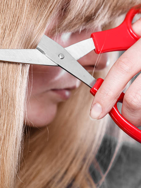 istock Blonde girl makes new hair image. 619647182