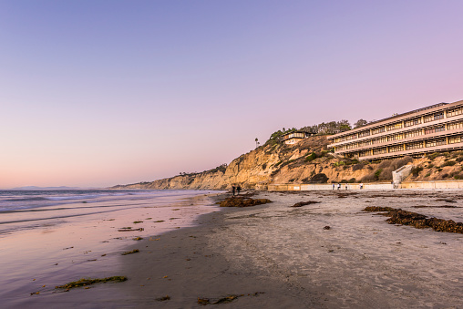 La Jolla, USA - November 7, 2015: Purple sunset on beach with Hubbs Hall at Scripps Institute of Oceanography in San Diego, California