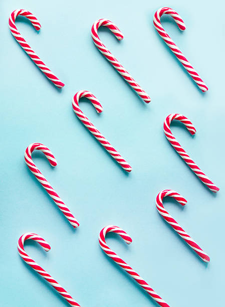 istock Christmas candy cane on blue background.  Flat lay. Top view. 619648598