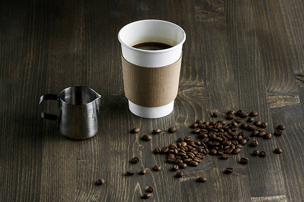 istock Coffee drink in a white cup, on a wooden background 619650994