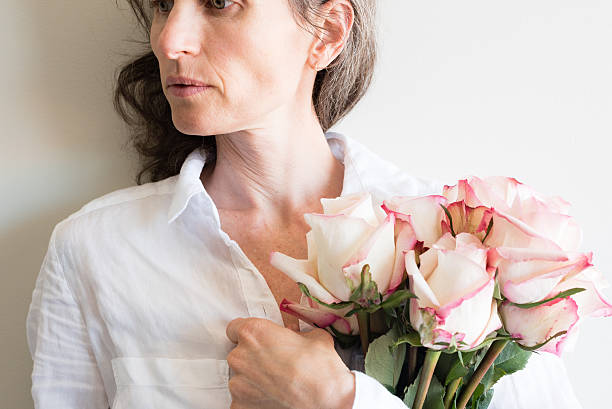 istock Middle aged woman holding roses 619652214