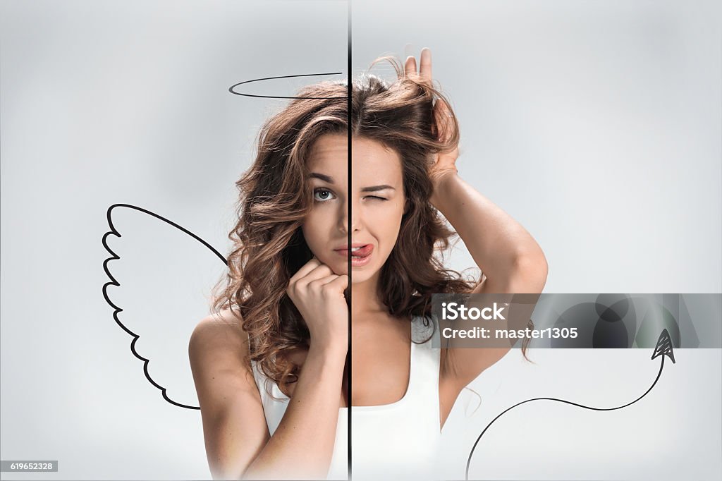 Photo of the girl with a different emotions on  face Photo of the girl with a different emotions on a face of the angel and the devil. Collage Angel Stock Photo