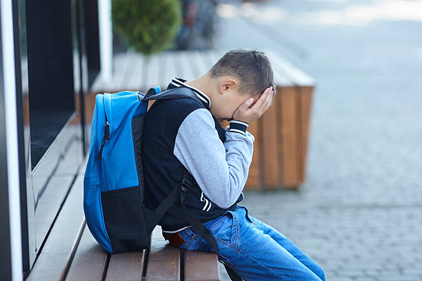 istock schoolboy crying on the street 619652568