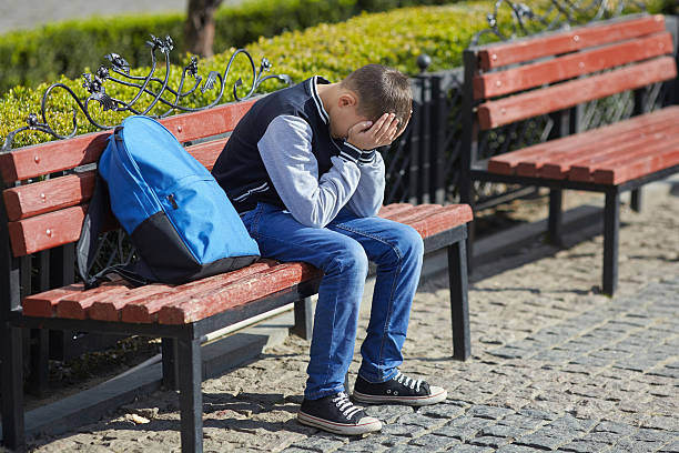 istock schoolboy crying on the street 619652642