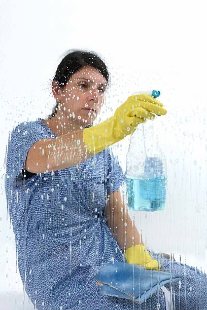 istock woman cleaning glass 619652650
