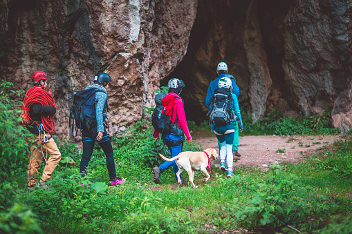 Five people entering a cave to explore it