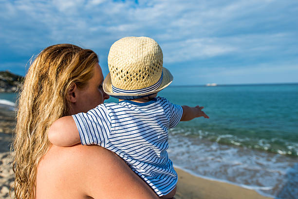 istock Mom with baby on the beach 619653344