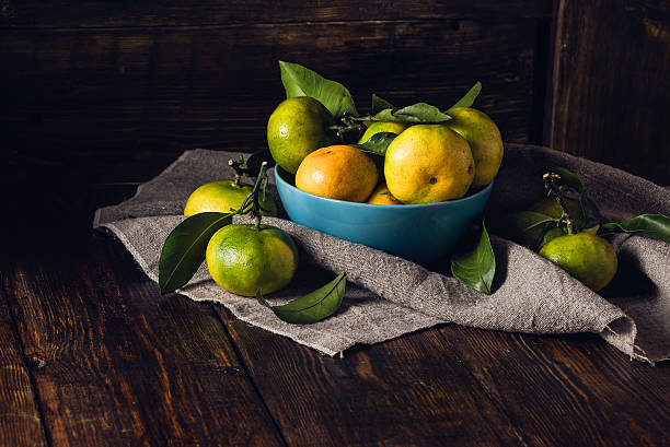 istock Still Life with Tangerines in Blue Bowl. 619654060