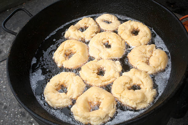 istock Frying donuts in hot olive oil. 619654062