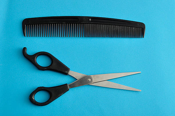 istock Hair cutting scissors and a comb 619654994