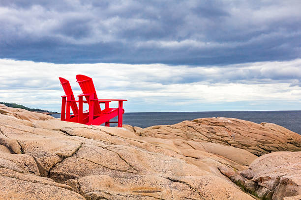 istock Red deck chairs in front of the river 619655154