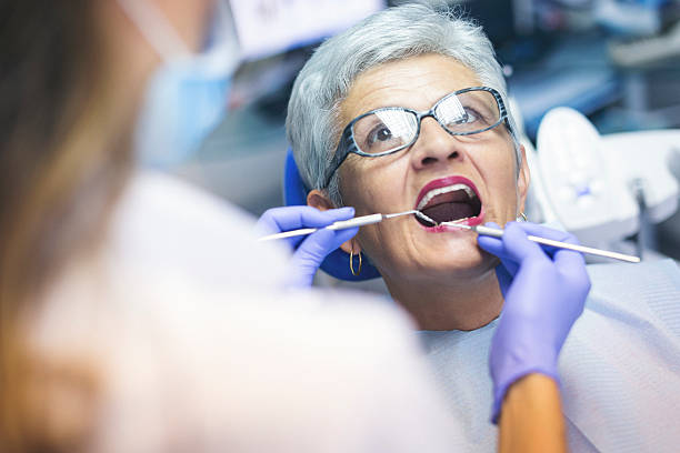 Senior female patient at dentist office stock photo