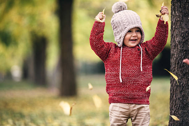 Cheerful cute child in the park stock photo
